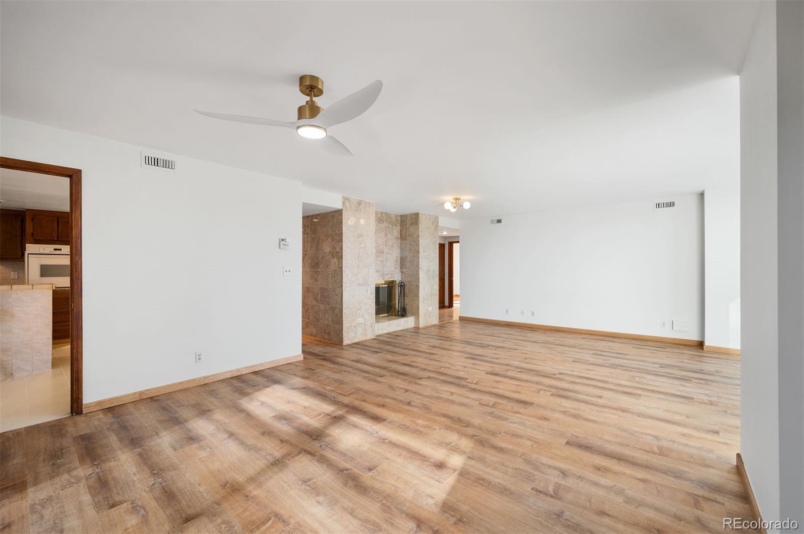 1777 Larimer Street, Unit 1010 Denver, CO 80202 - Photo 13 of 48 a view of an empty room with wooden floor and a ceiling fan