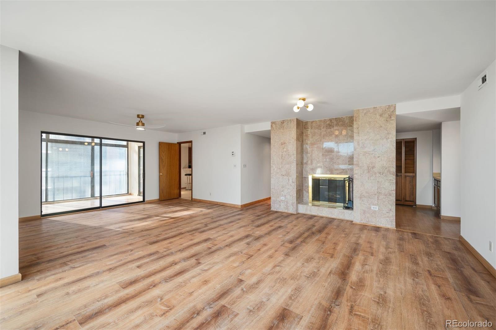 1777 Larimer Street, Unit 1010 Denver, CO 80202 - Photo 6 of 48 a view of an empty room with window and wooden floor