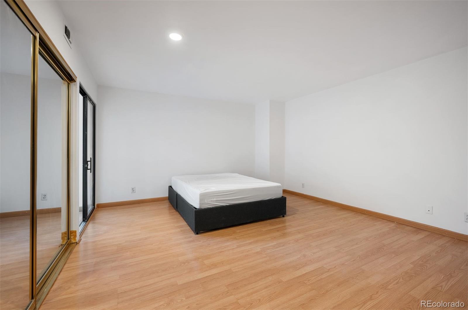 1777 Larimer Street, Unit 1010 Denver, CO 80202 - Photo 8 of 48 a view of empty room with wooden floor