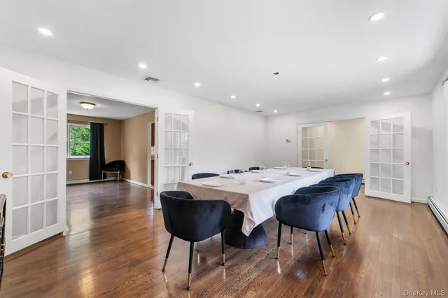a view of a dining room with furniture wooden floor and chandelier