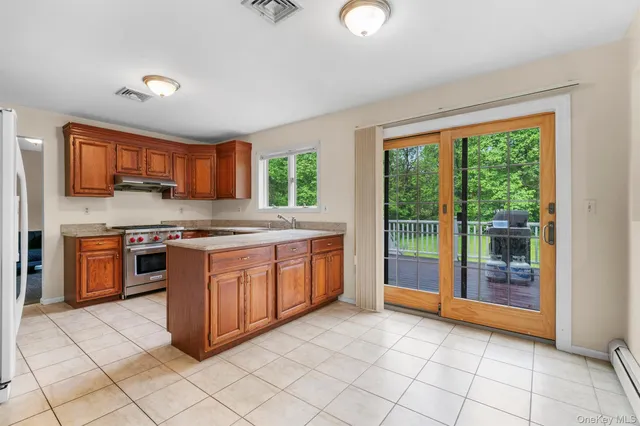 a kitchen with stainless steel appliances granite countertop a stove sink and cabinets