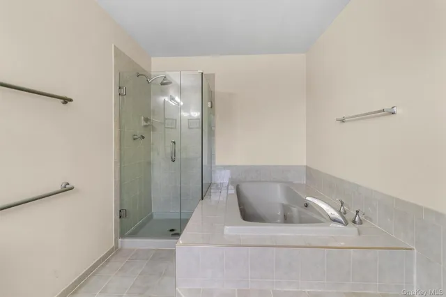 a bathroom with a bathtub and shower