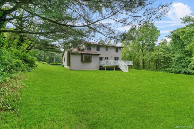 a view of a house with backyard sitting area and garden