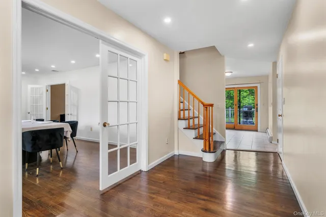 a view of entryway with wooden floor and stairs