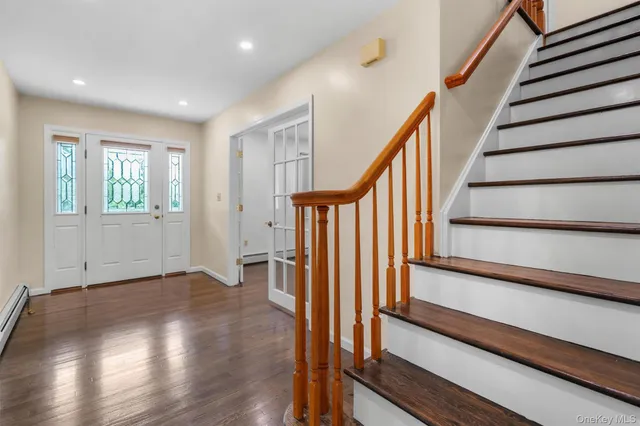 a view of entryway with wooden floor and stairs