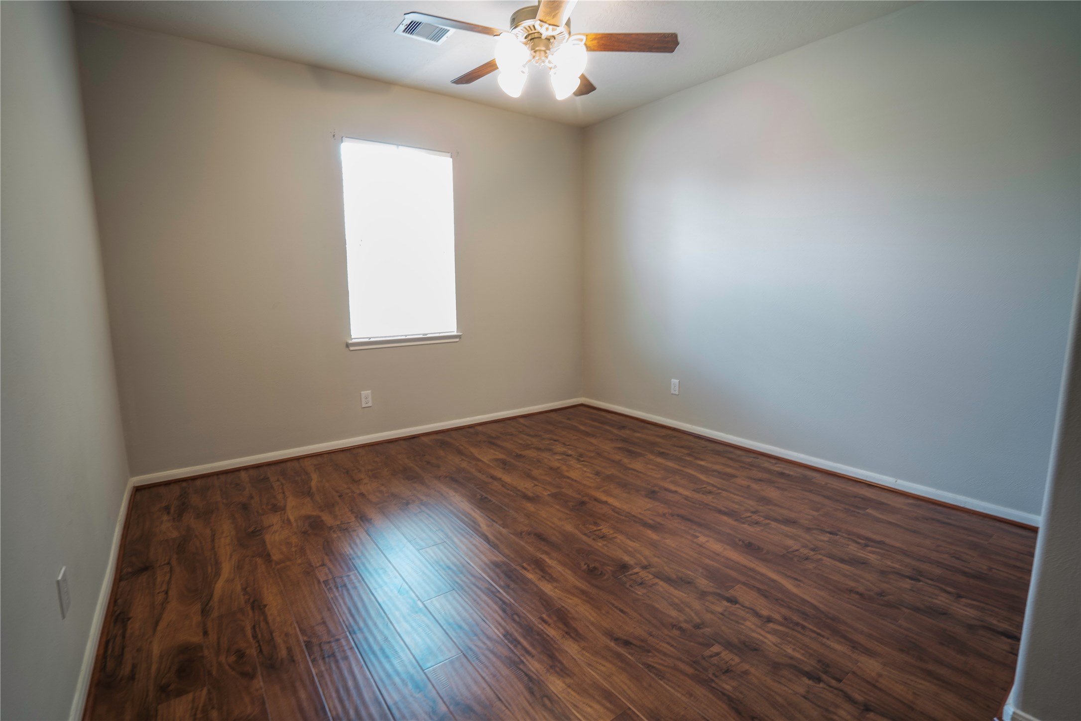 8811 Henrico Lane Rosenberg, TX 77469 - Photo 17 of 18 wooden floor in an empty room with a window