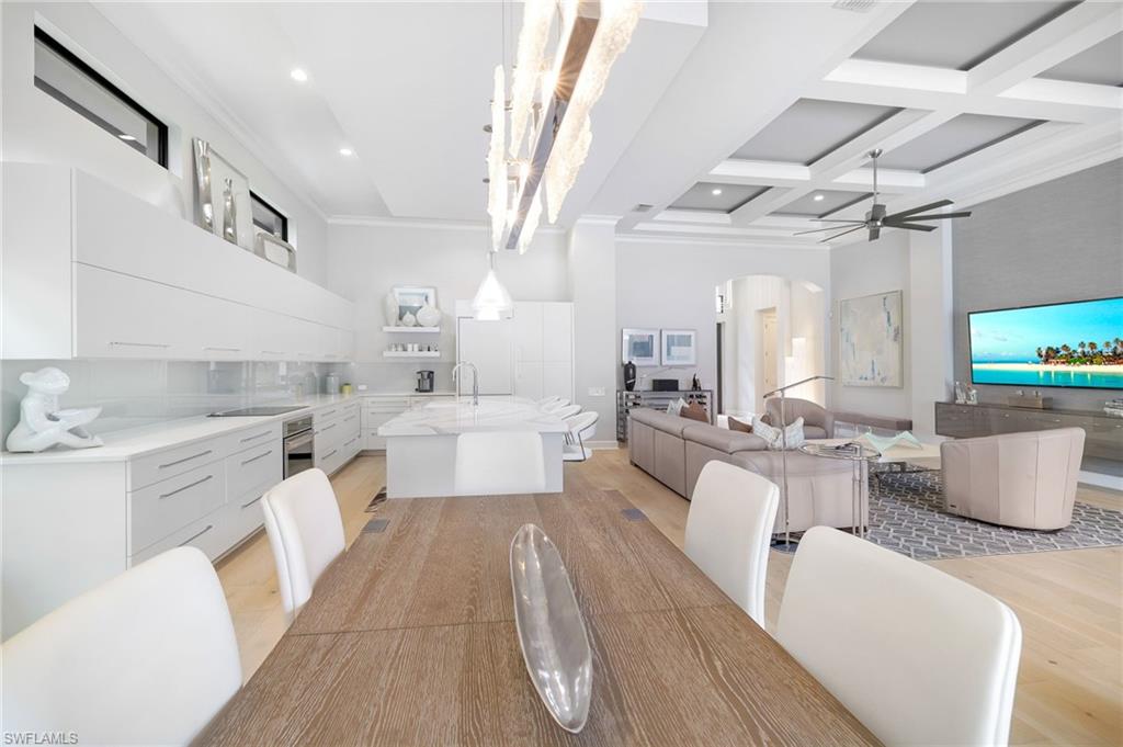 17441 Via Lugano Court Miromar Lakes, FL 33913 - Photo 11 of 40 a large white kitchen with a white countertops a fireplace and a couch