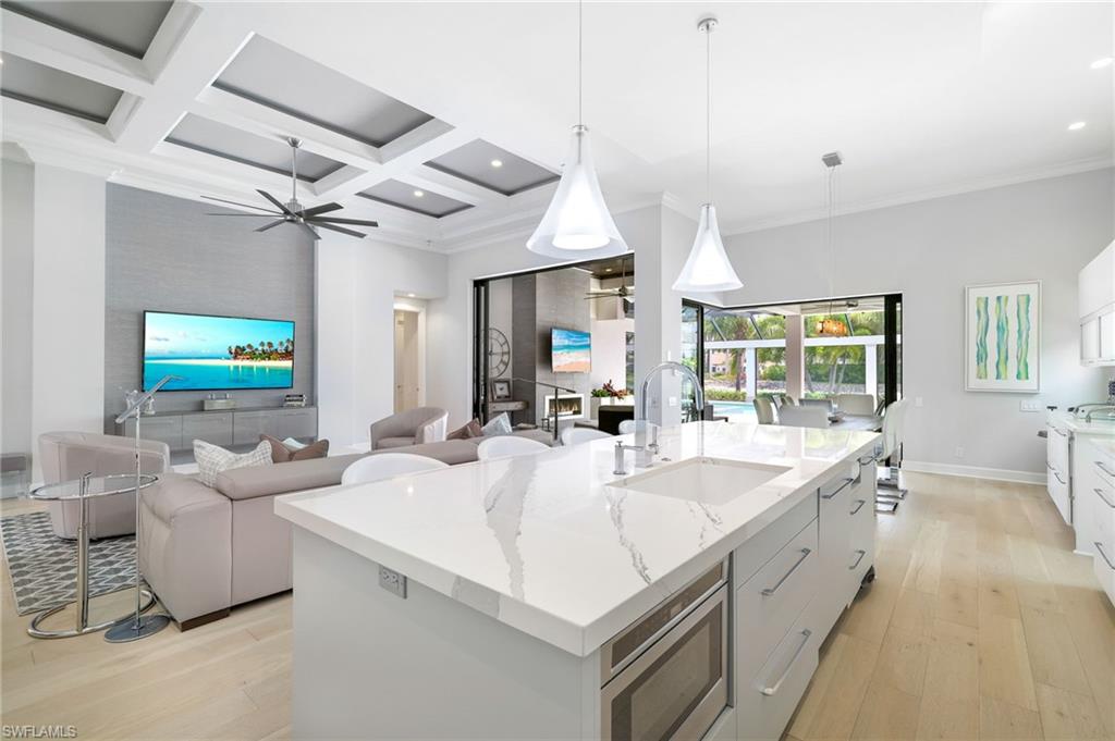 17441 Via Lugano Court Miromar Lakes, FL 33913 - Photo 12 of 40 a large white kitchen with a large window and stainless steel appliances