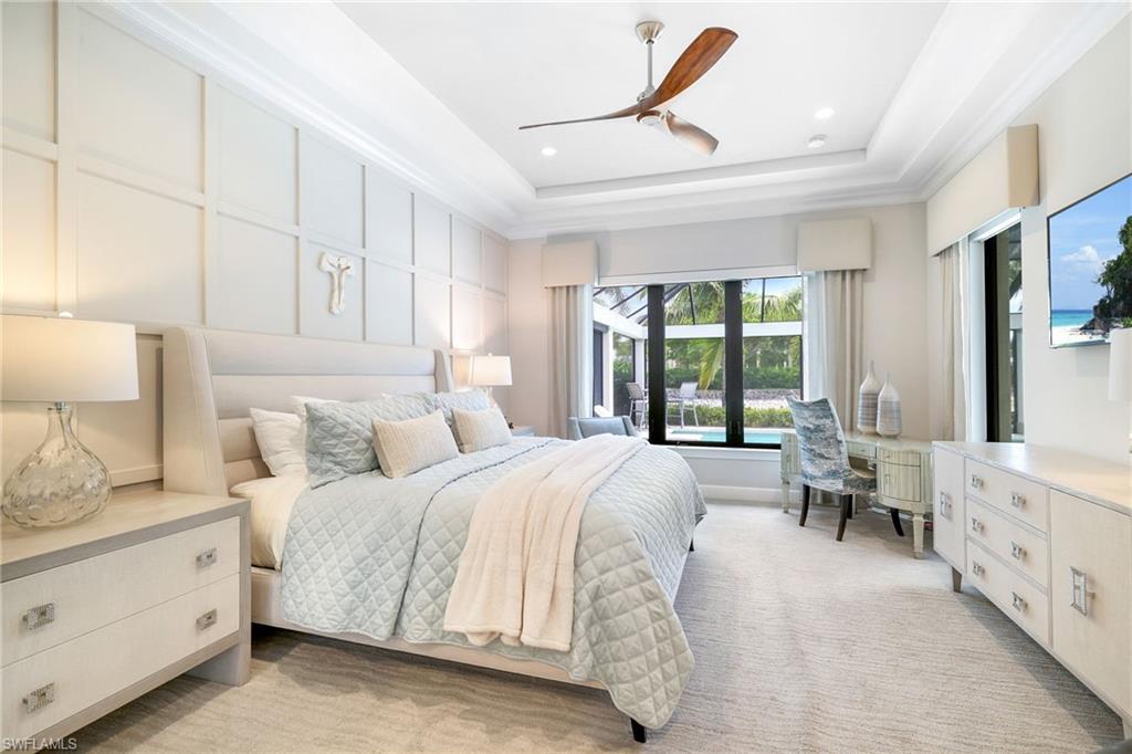 17441 Via Lugano Court Miromar Lakes, FL 33913 - Photo 14 of 40 a spacious bedroom with a bed and a window