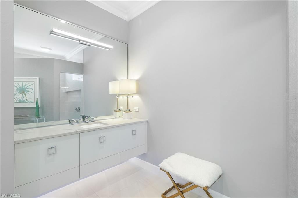 17441 Via Lugano Court Miromar Lakes, FL 33913 - Photo 16 of 40 a bathroom with a sink a toilet and a mirror