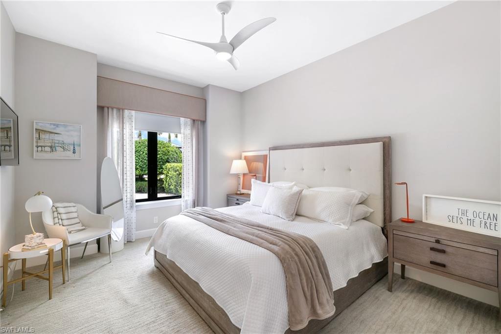 17441 Via Lugano Court Miromar Lakes, FL 33913 - Photo 17 of 40 a bedroom with a bed and a chandelier