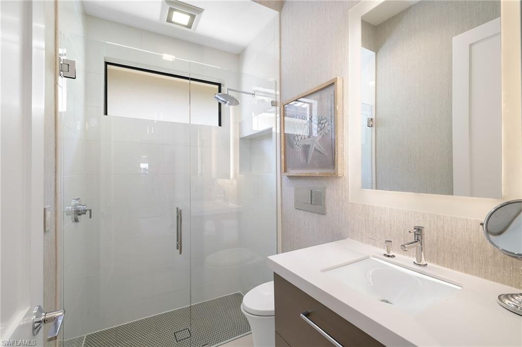 17441 Via Lugano Court Miromar Lakes, FL 33913 - Photo 18 of 40 a bathroom with a sink toilet and shower