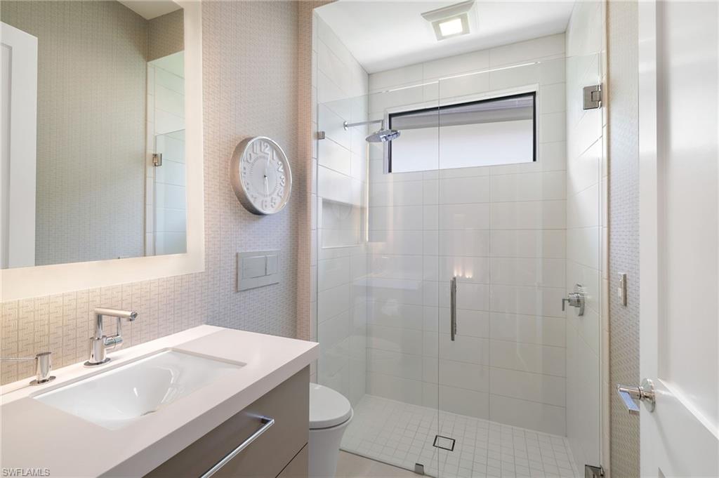 17441 Via Lugano Court Miromar Lakes, FL 33913 - Photo 21 of 40 a bathroom with a sink a toilet and shower