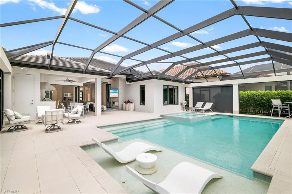 17441 Via Lugano Court Miromar Lakes, FL 33913 - Photo 23 of 40 a view of a swimming pool with a patio