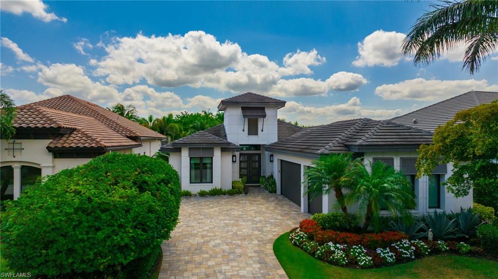 17441 Via Lugano Court Miromar Lakes, FL 33913 - Photo 28 of 40 a front view of a house with a garden