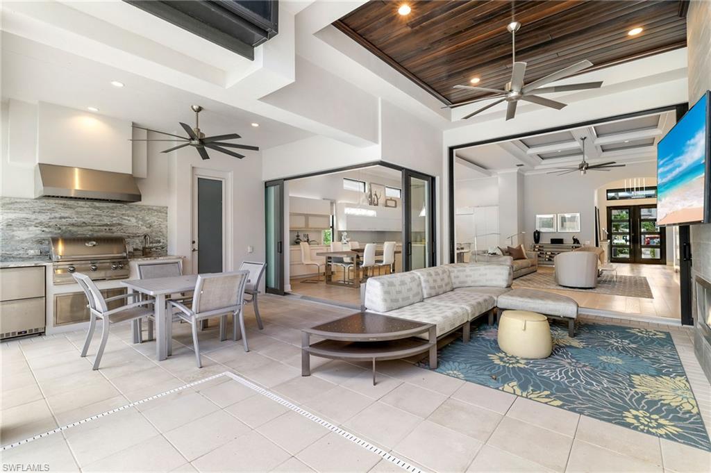 17441 Via Lugano Court Miromar Lakes, FL 33913 - Photo 4 of 40 a living room with furniture and a fireplace