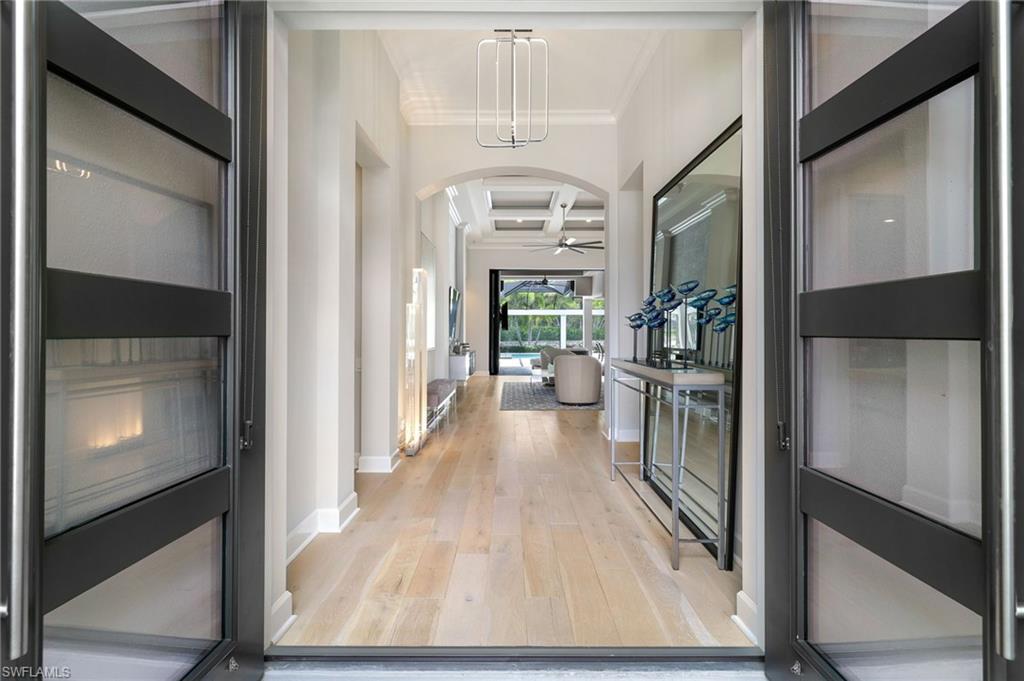 17441 Via Lugano Court Miromar Lakes, FL 33913 - Photo 5 of 40 a view of a hallway with wooden floor windows and livingroom