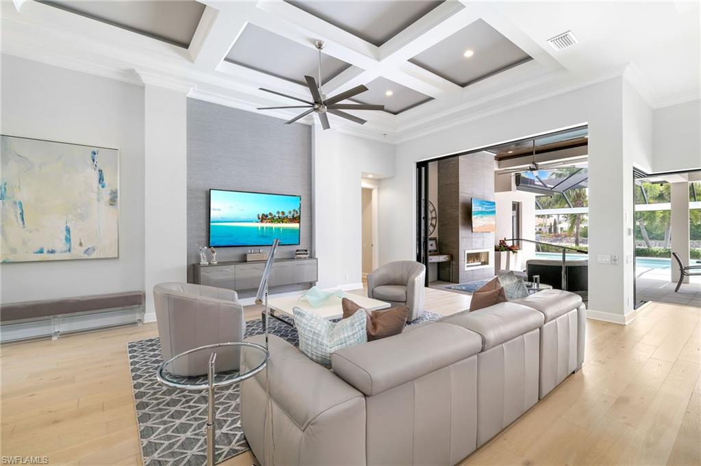 17441 Via Lugano Court Miromar Lakes, FL 33913 - Photo 8 of 40 a living room with furniture and a flat screen tv