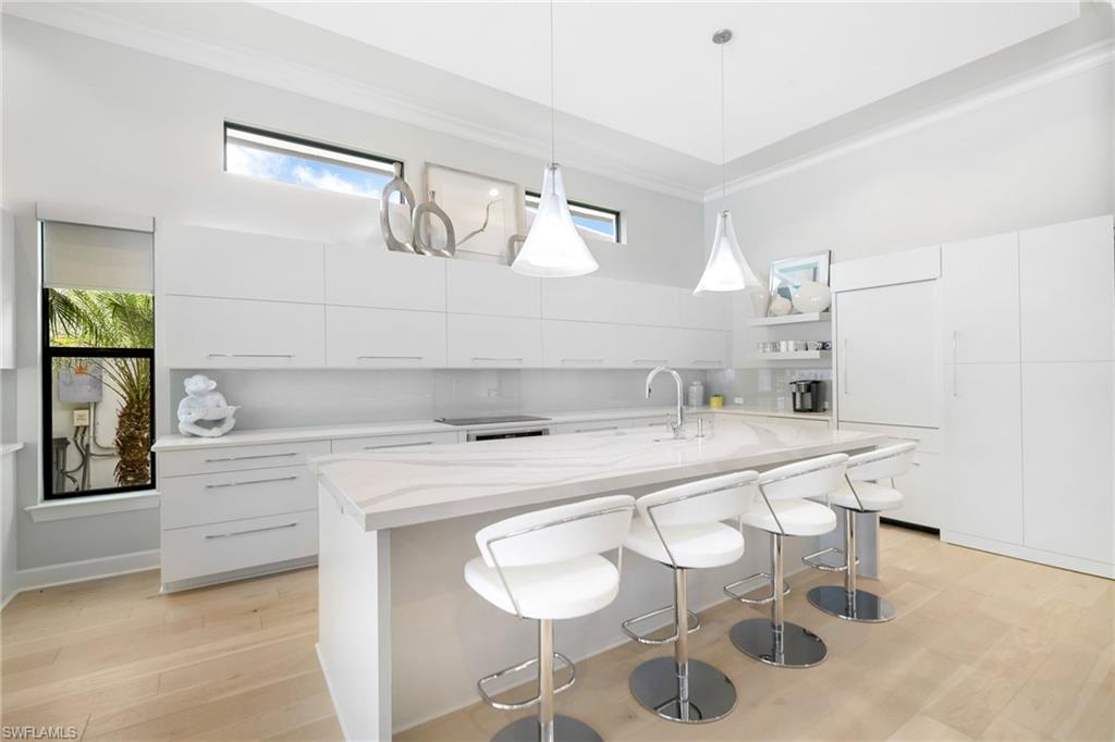 17441 Via Lugano Court Miromar Lakes, FL 33913 - Photo 10 of 40 a kitchen with a sink and chairs