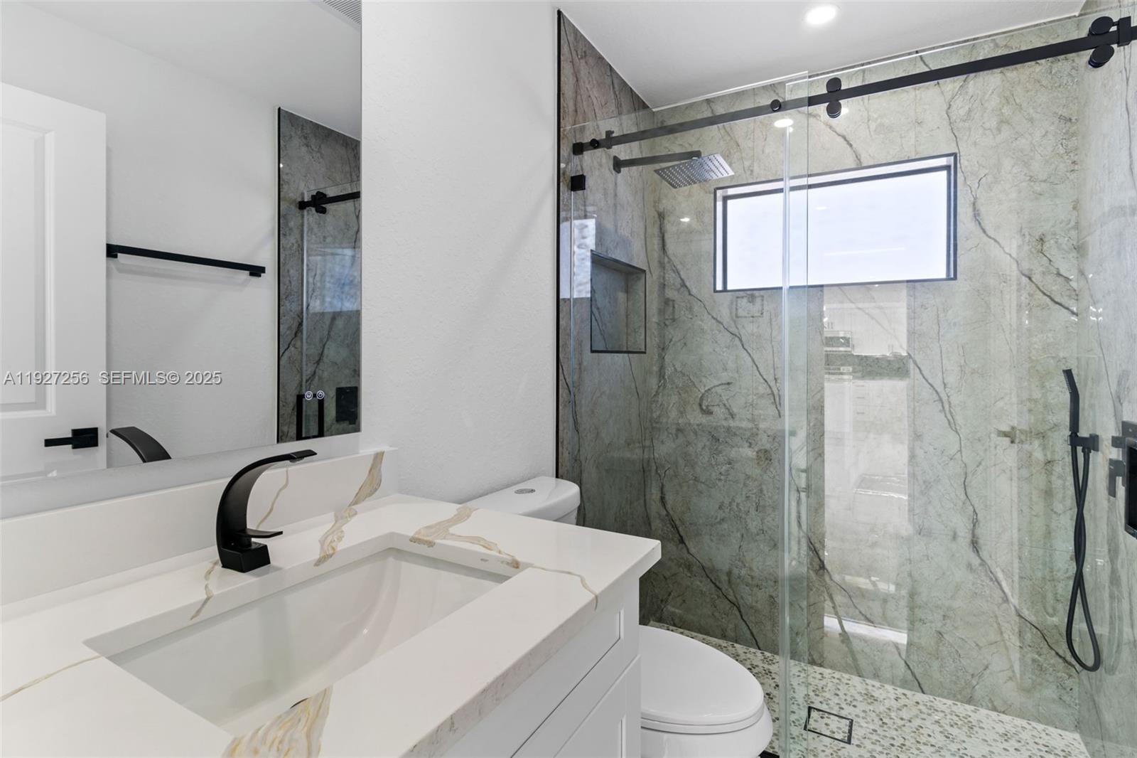 3419 16th Street Southwest Lehigh Acres, FL 33976 - Photo 15 of 46 a bathroom with a sink toilet and shower