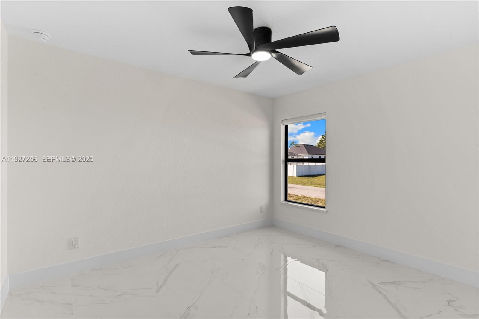 3419 16th Street Southwest Lehigh Acres, FL 33976 - Photo 16 of 46 an empty room with windows and ceiling fan