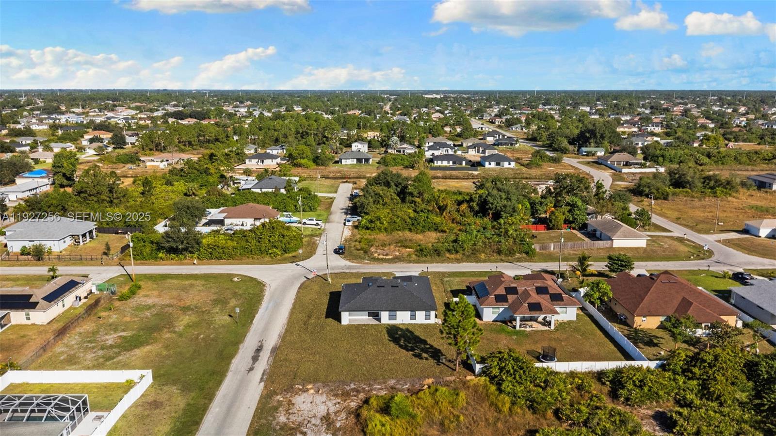 3419 16th Street Southwest Lehigh Acres, FL 33976 - Photo 39 of 46 an aerial view of residential houses with outdoor space