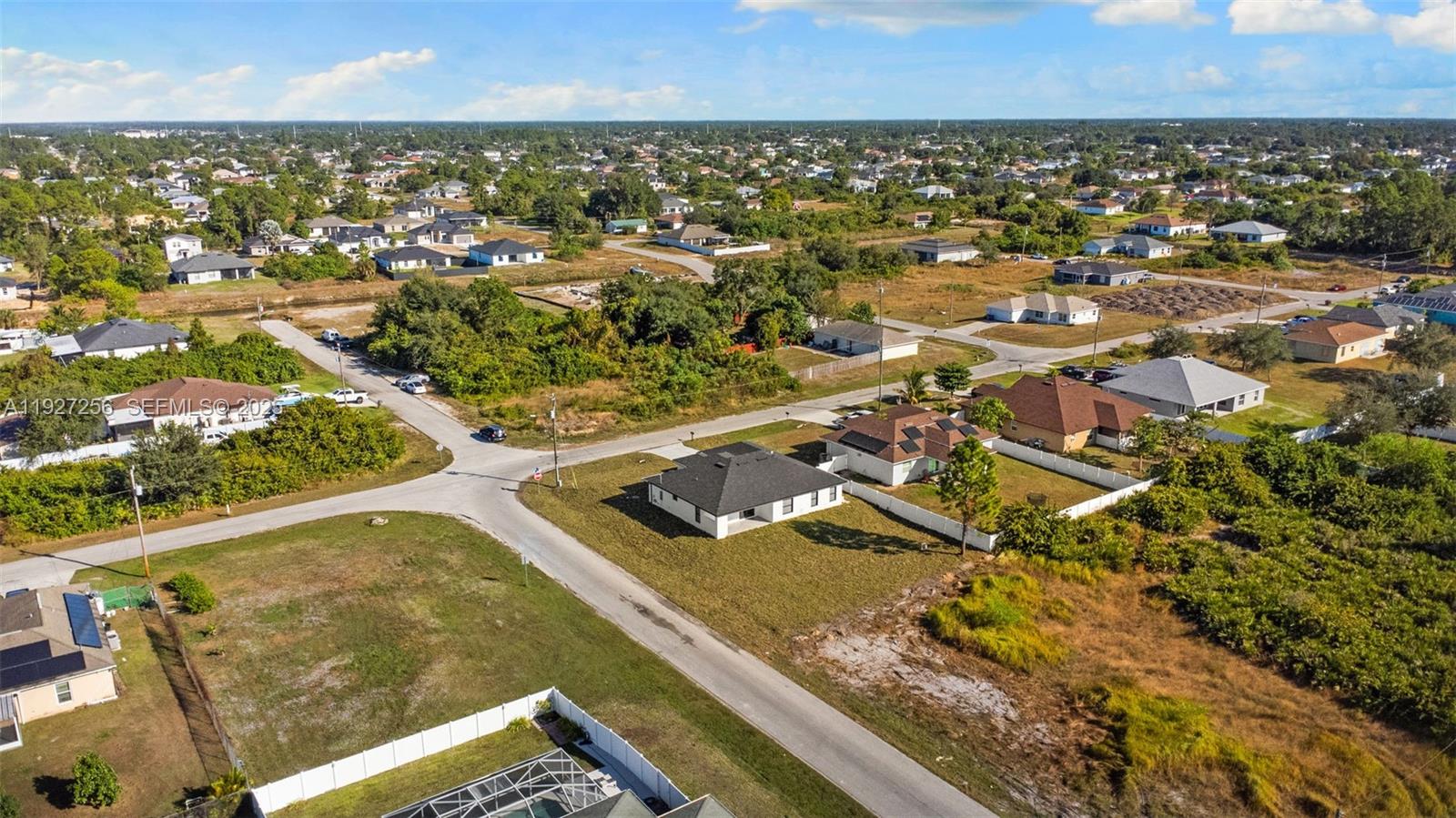 3419 16th Street Southwest Lehigh Acres, FL 33976 - Photo 41 of 46 an aerial view of residential houses with outdoor space