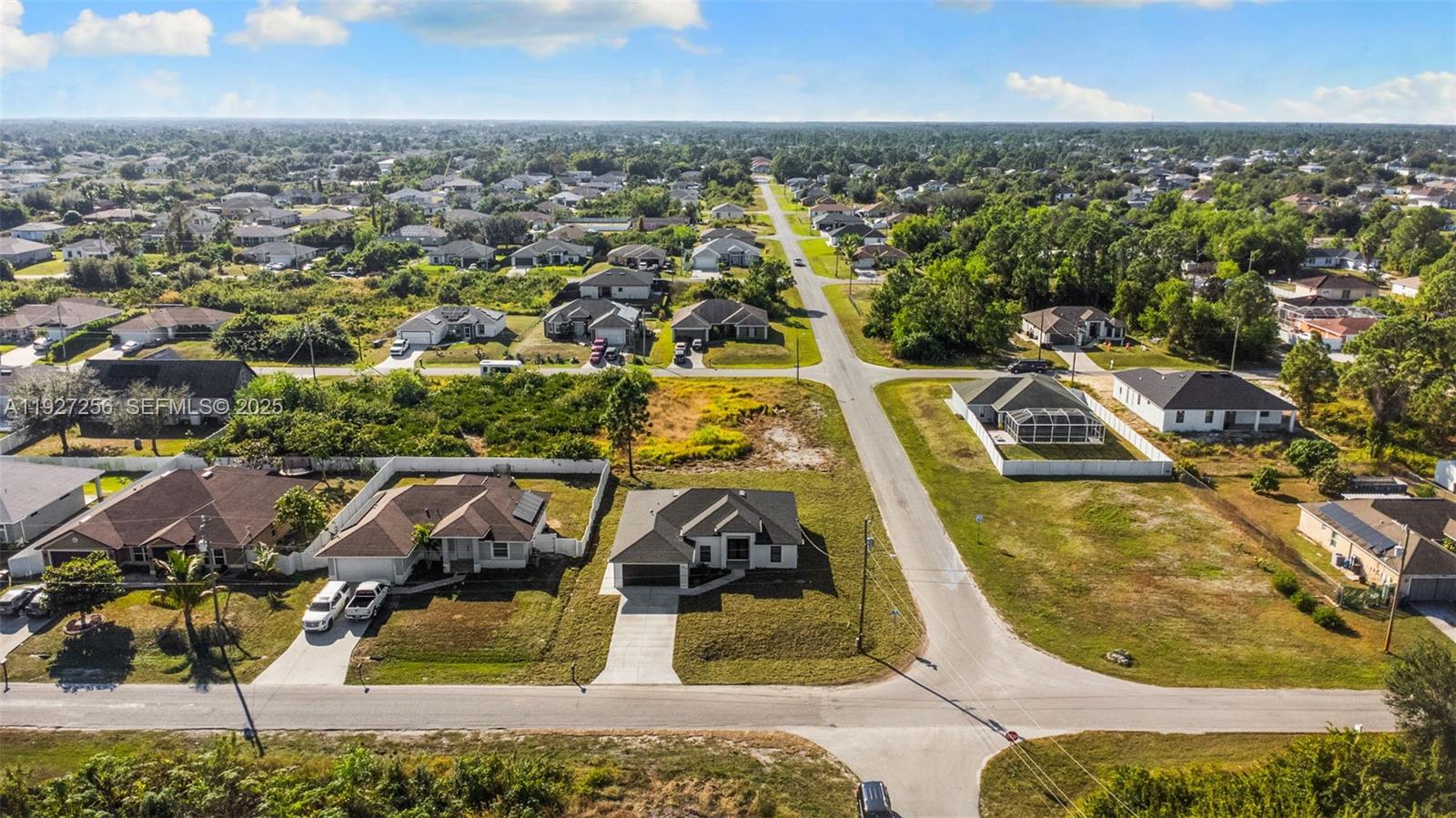 3419 16th Street Southwest Lehigh Acres, FL 33976 - Photo 42 of 46 an aerial view of residential houses with outdoor space