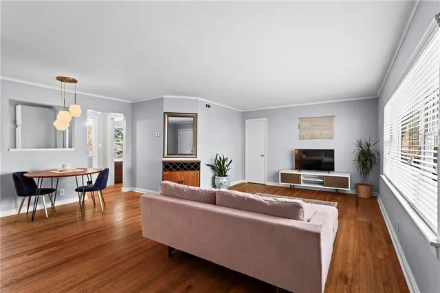 a living room with furniture wooden floor and a fireplace