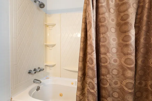 a bathroom with a bathtub and shower