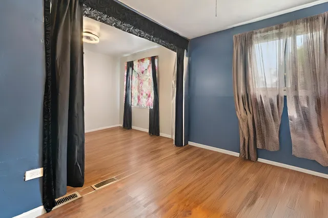 an empty room with windows and closet