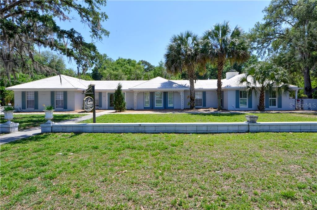 5208 Northeast 24th Street Ocala, FL 34470 - Photo 1 of 31 a view of a swimming pool with lawn chairs under an umbrella
