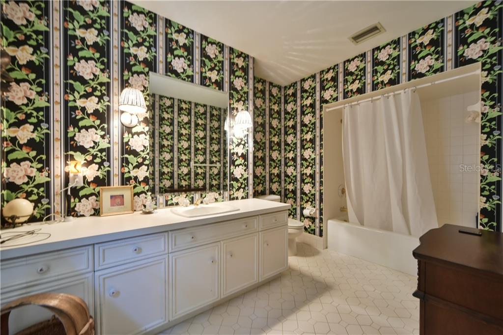5208 Northeast 24th Street Ocala, FL 34470 - Photo 12 of 31 a bathroom with a double vanity sink and mirror