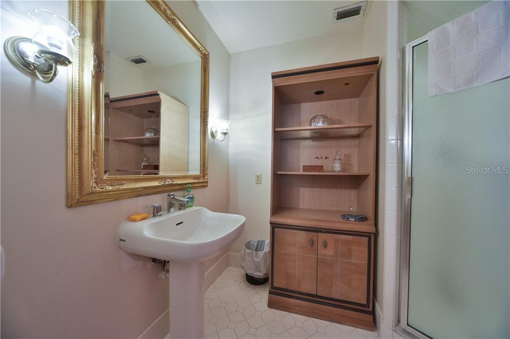 5208 Northeast 24th Street Ocala, FL 34470 - Photo 17 of 31 a bathroom with a sink a toilet and shower