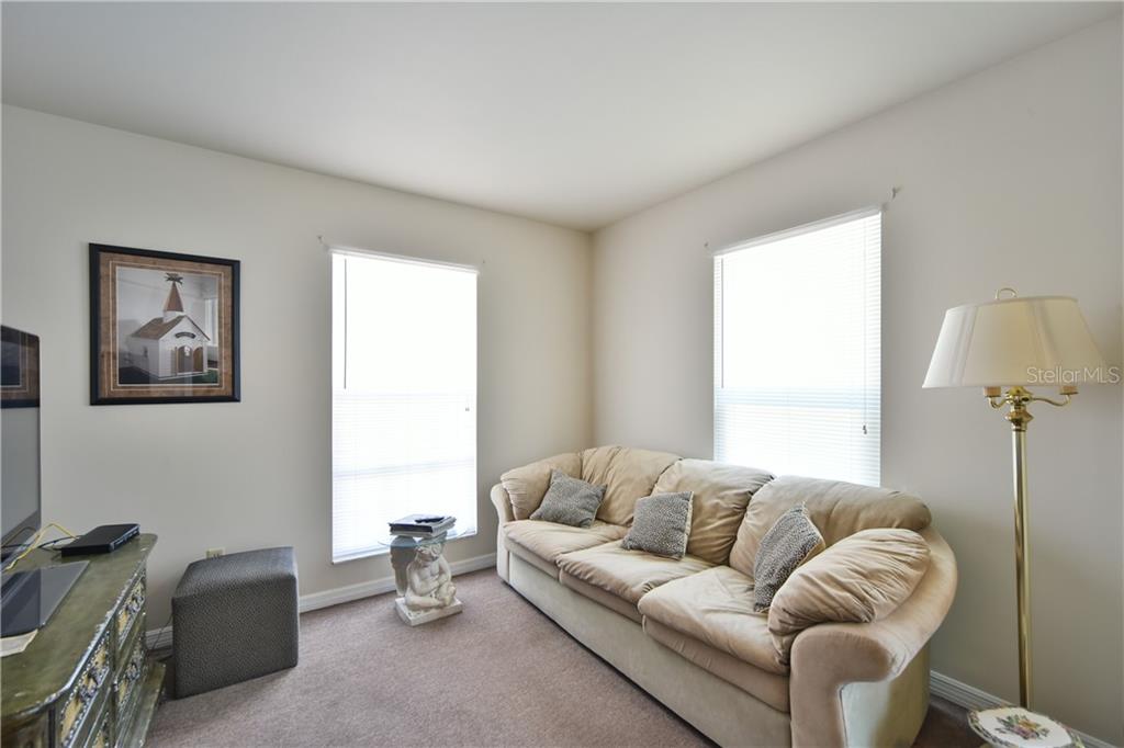 5208 Northeast 24th Street Ocala, FL 34470 - Photo 19 of 31 a living room with furniture and a lamp