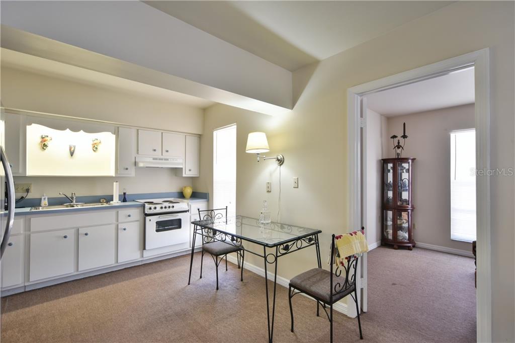 5208 Northeast 24th Street Ocala, FL 34470 - Photo 22 of 31 a kitchen with granite countertop a sink cabinets and stainless steel appliances