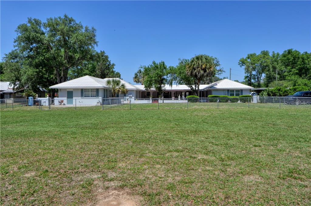 5208 Northeast 24th Street Ocala, FL 34470 - Photo 24 of 31 a view of a house with a yard porch and sitting area