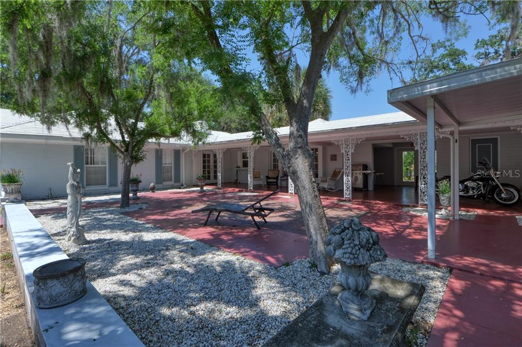 5208 Northeast 24th Street Ocala, FL 34470 - Photo 25 of 31 a view of a house with backyard and sitting area