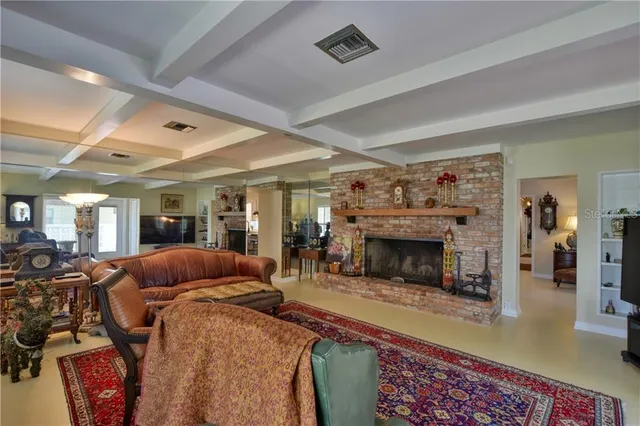 a living room with furniture a fireplace and a table