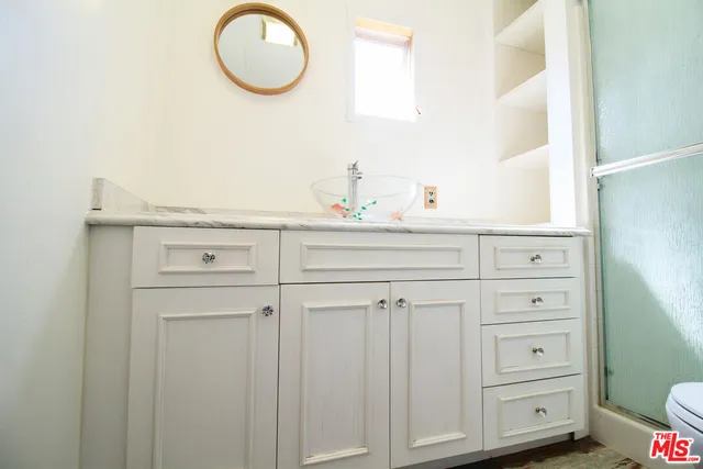 a bathroom with a sink vanity and mirror
