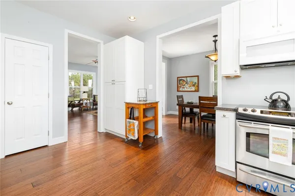 a view of a dining room with furniture wooden floor and a window