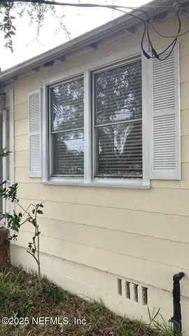 a bathroom with a window and a shower