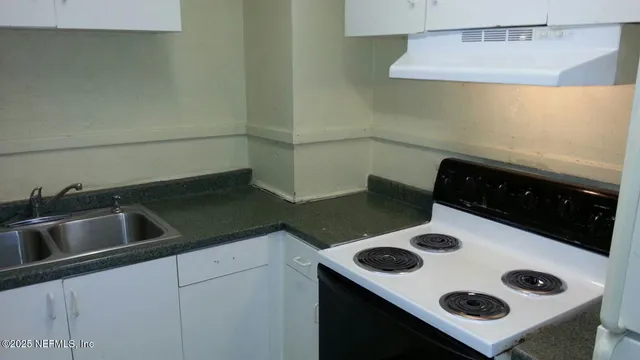 a kitchen with a stove and a refrigerator