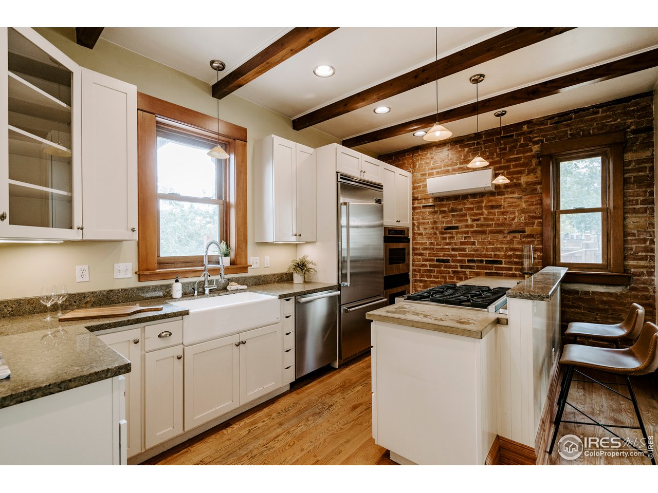 1718 Mapleton Avenue Boulder, CO 80302 - Photo 11 of 40 a kitchen that has a sink a stove and chairs