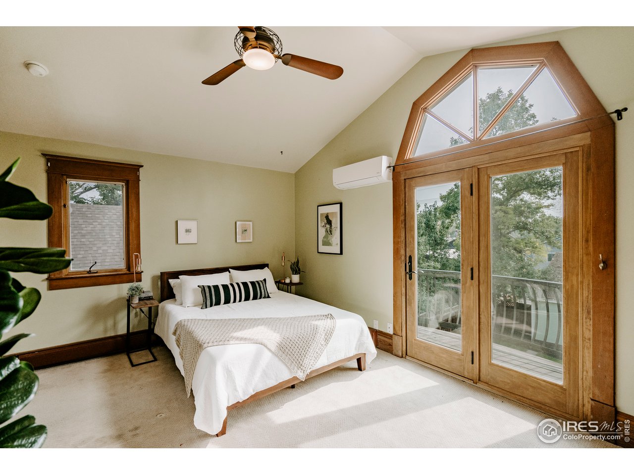 1718 Mapleton Avenue Boulder, CO 80302 - Photo 18 of 40 a bedroom with a large bed and a chandelier