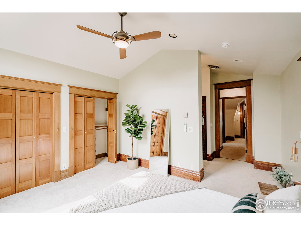 1718 Mapleton Avenue Boulder, CO 80302 - Photo 20 of 40 a bedroom with a bed and a chandelier