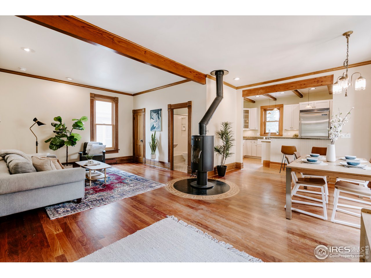 1718 Mapleton Avenue Boulder, CO 80302 - Photo 5 of 40 a living room with furniture a wooden floor and a large window