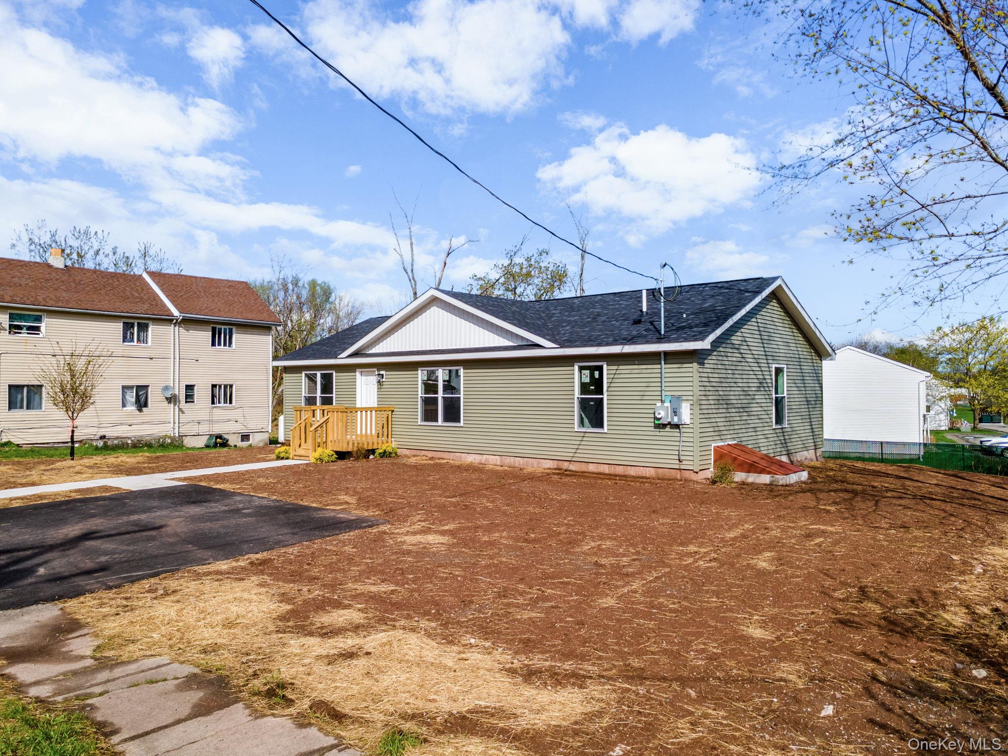 23 Spring Street Monticello, NY 12701 - Photo 2 of 44 a front view of a house with a yard