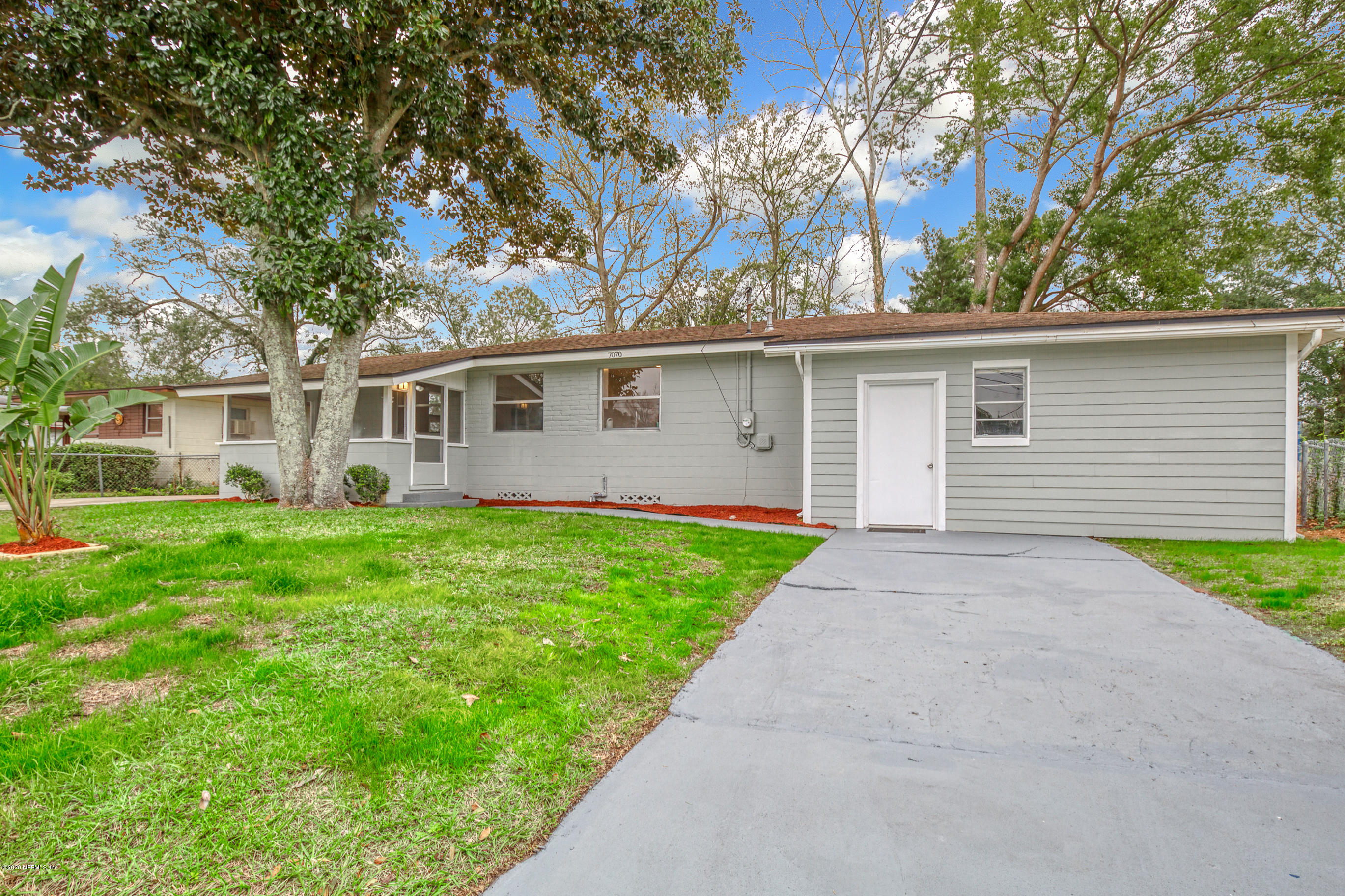 a front view of house with yard and green space