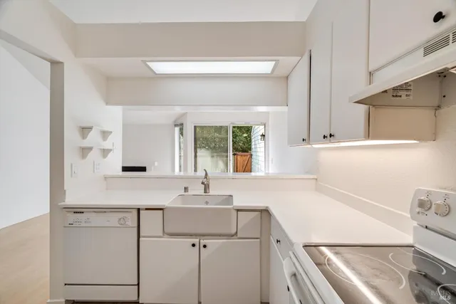 a kitchen with a sink cabinets and window